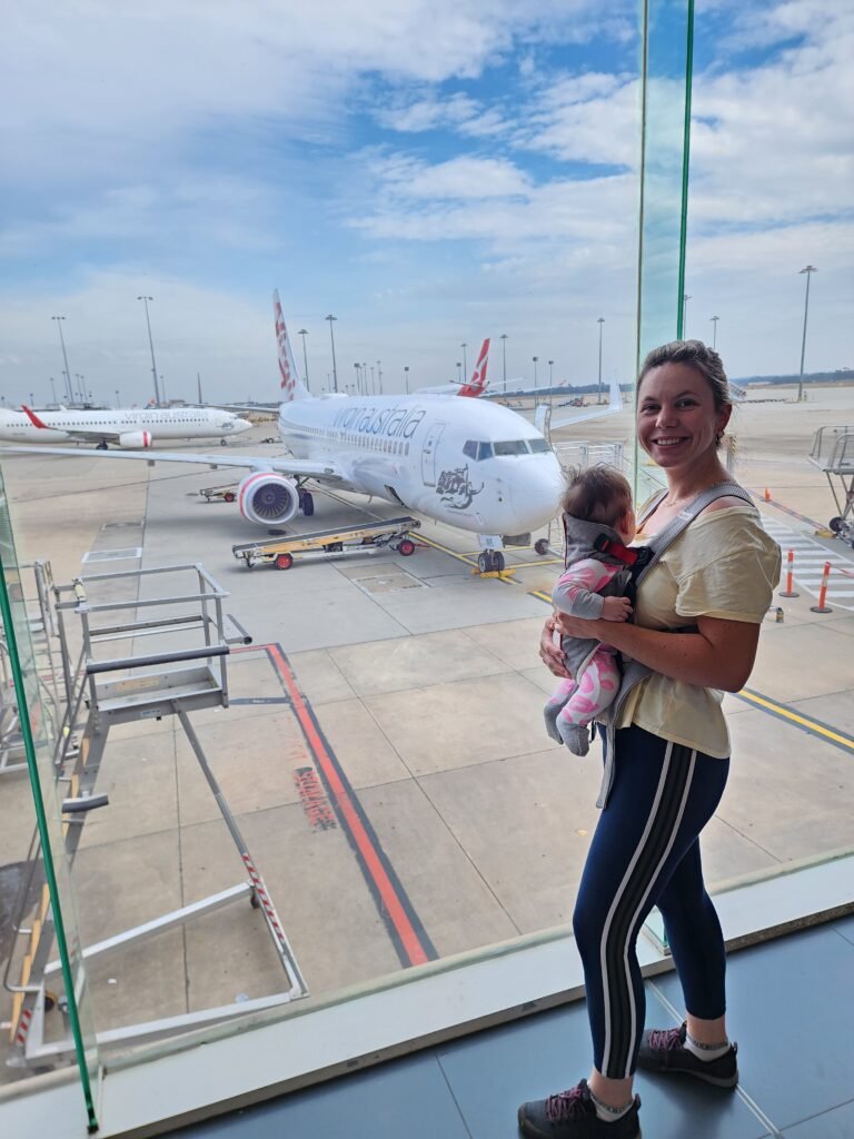 Family travelling through an airport with a baby