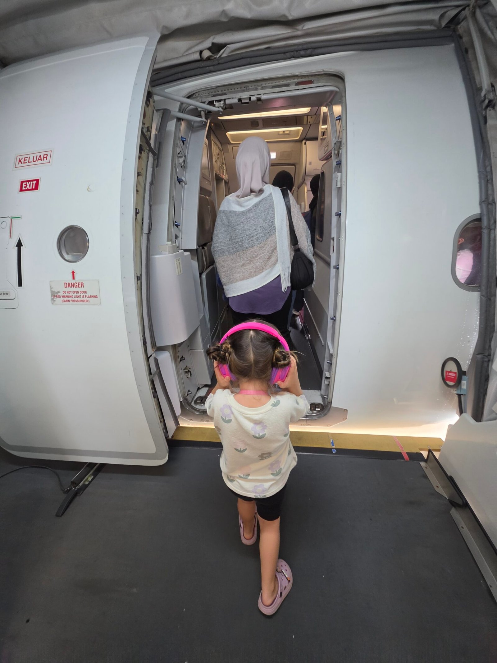 young child boarding an aeroplane
