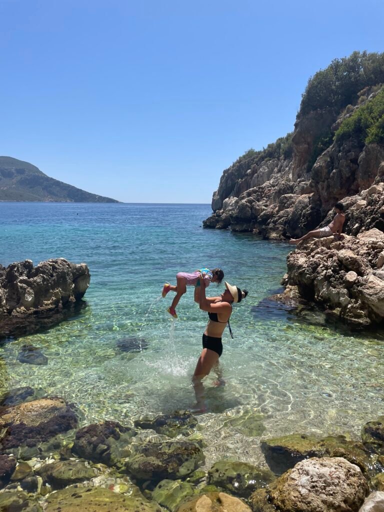young child and her mum playing in the ocean in turkiye