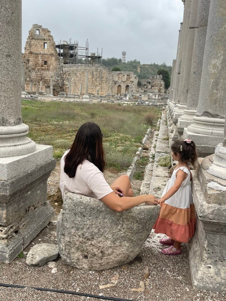 Mum and young daughter exploring ancient ruins while travelling