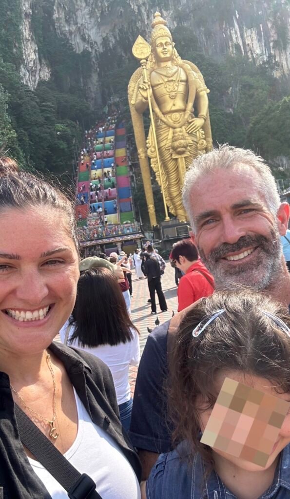 family standing outside Batu Caves in Malaysia